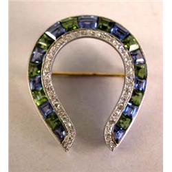 A GOLD SAPPHIRE DIAMOND AND PERIDOT HORSE SHOE PIN