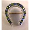 Image 1 : A GOLD SAPPHIRE DIAMOND AND PERIDOT HORSE SHOE PIN