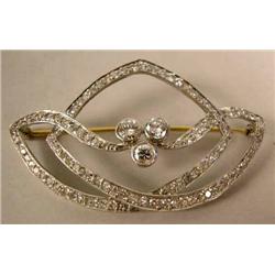 A TIFFANY & CO. PLATINUM AND DIAMOND RIBBON MOTIF BROOCH