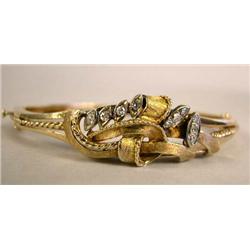 A YELLOW GOLD AND DIAMOND BANGLE BRACELET