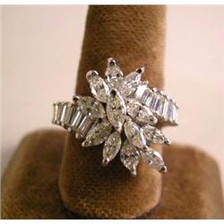 A 14K WHITE GOLD AND DIAMOND CROSS-OVER STYLE RING