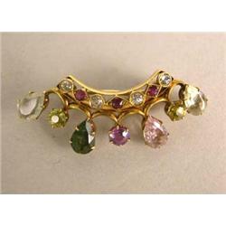 A GROUP OF GOLD PINS WITH STONES