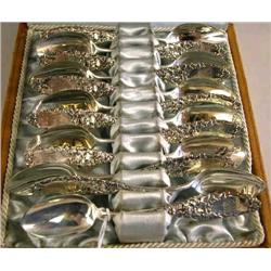 A SET OF TWELVE TIFFANY & CO. "IVY" PATTERN STERLING SILVER DEMITASSE SPOONS IN ORIGINAL LEATHER WIT