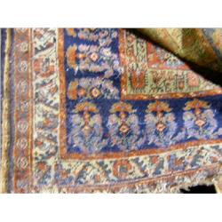 A LARGE TRIBAL ORIENTAL RUG