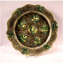 A GREEN, YELLOW AND BROWN MAJOLICA CHARGER