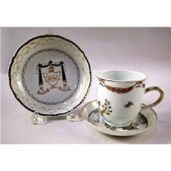 A CHINESE EXPORT CUP AND TWO SAUCERS