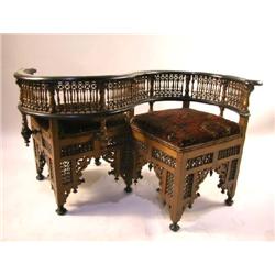 A MOORISH STYLE MOTHER-OF-PEARL-INLAID EBONIZED WALNUT TETE A TETE