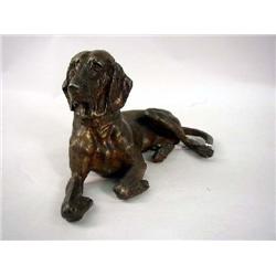A PATINATED METAL FIGURE OF A HOUND DOG