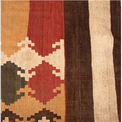 A KILIM IN TONES OF GREEN, RED, YELLOW AND WHITE
