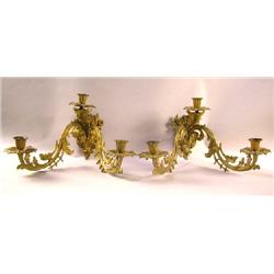 A PAIR OF PATINATED METAL THREE LIGHT WALL SCONCES