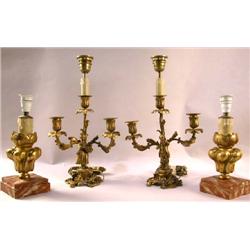 A PAIR OF PATINATED METAL THREE-LIGHT CANDELABRAS