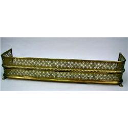 A REGENCY PIERCED BRASS FIRE FENDER
