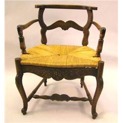 A LOUIS XV PROVINCIAL STYLE CARVED WALNUT LOWBACK, RUSH SEAT FAUTEUIL