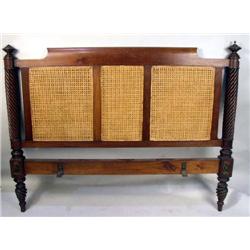 A COLONIAL STYLE CARVED HARDWOOD CANED BEDSTEAD