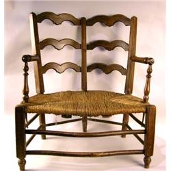 A LOUIS XV STYLE BEECHWOOD DOUBLE CHAIRBACK RUSH SEAT SETTEE
