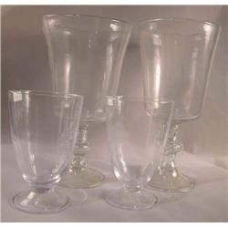 A NEAR PAIR OF COLORLESS GLASS CHALICES