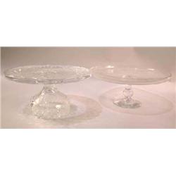 TWO COLORLESS GLASS FOOTED CAKE STANDS