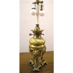 A ROCOCO STYLE KEROSENE ORMOLU MOUNTED TABLE LAMP