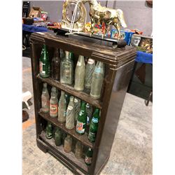 Book shelf w/brass clock horse and old pop bottles