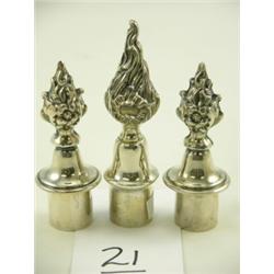 Three silver bottle stoppers, one 4"H, two 3½"H