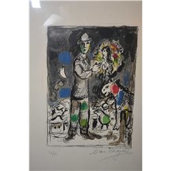 Framed limited edition coloured lithograph of a man holding a portrait of a woman signed by artist M