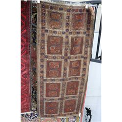 Persian wool carpet with copper colour background, geometric panels with highlights of blue, orange,