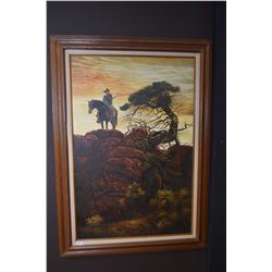 Large framed oil on canvas painting of a mounted cowboy with drawn rifle on a rocky ridge, no artist