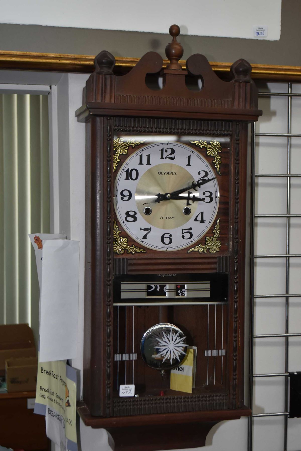 Wall mounted 31 day chiming clock made by Olympia with day and date display
