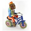 Image 1 : Toys (1992) An oversized vintage Monkey riding a tricycle clockwork tinplate toy used in the Zevo To