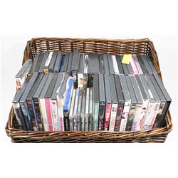 LOT OF DVDS & CDS IN WICKER BASKET.