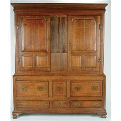 Mid 18th Century Oak Cupboard  the upper section fitted double fielded panel doors centered by a flu