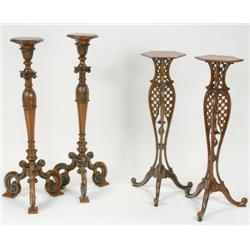 Pair of Edwardian Walnut Pedestals each with a circular top and turned pedestal with carved acanthus