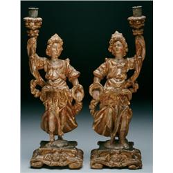 Pair of Italian Giltwood Figural Candlesticks each figure with arm raised supporting a scrolling fol
