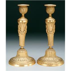 Pair of French Gilt Brass Candlesticks moulded with bands of flutes and leaves and bead borders and 