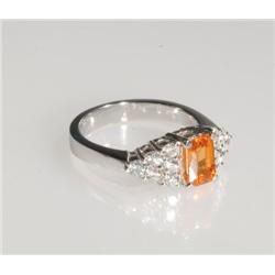 18k White Gold Cocktail Ring set with a scissor cut orange sapphire (approx. 1.32ct.) flanked by 12 