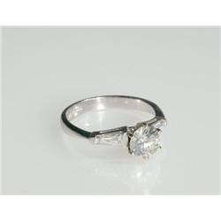 Platinum Solitaire Ring set with a brilliant cut diamond (approx. 1.00ct.) flanked by 2 tapered bagu