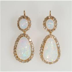 Pair Of 18k Yellow Gold Hook Back Drop Earrings each set with an oval cut opal cabochon (approx. 8.3