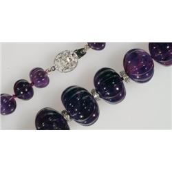 Single Graduated Strand Of Carved Ovoid Amethyst Beads with an 18k white gold filigree clasp and 14 