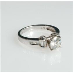 18k White Gold Solitaire Ring set with a brilliant cut diamond (approx. 1.06ct.) flanked by scrolls 