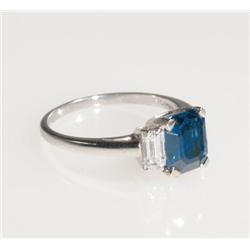 Platinum Cocktail Ring set with an emerald cut sapphire (approx. 2.25ct.) flanked by 2 baguette cut 