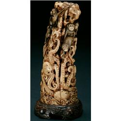 Ivory Okimono of Monkeys arrayed on a columnar rock teasing several octopuses, ht. 8.3"" - 21 cm., m
