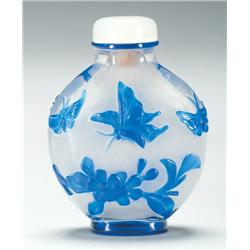 Beijing Glass Snuff Bottle of flask form, well carved with butterflies and flowers in blue on clear 