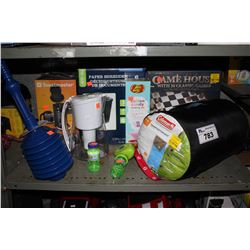 SHELF OF HOME ITEMS INCLUDING SHREDDER, BOARD GAMES, SLEEPING BAG, AND MORE