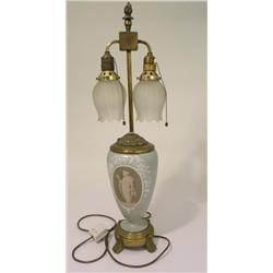A 19th century English twin light brass mounted pate-sur-pate table lamp, with an ovoid body decorat