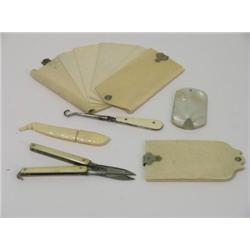 Three 19th century ivory aide-memoirs, a button hook, folding scissors and a bean shaped bodkin case