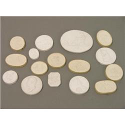 A collection of sixteen small plaster plaques, including Grand Tour souvenirs and historical figures