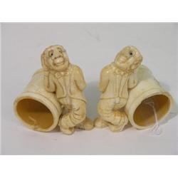 A pair of novelty figurine napkin rings, modelled as a long nosed man in tails  