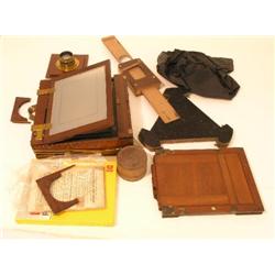 A mahogany full plate camera, with brass fittings and accessories including a copy of Burton's Moder