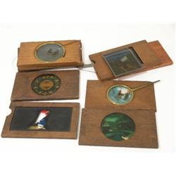 A collection of twelve magic lantern slides, including some with names and sliding animations  
