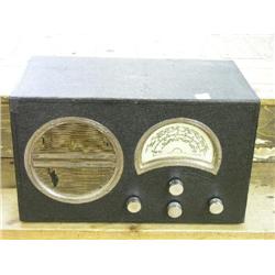 A 1932 Marconi radio, with chrome rimmed circular speaker and crescent tuning panel, 16.5ins  